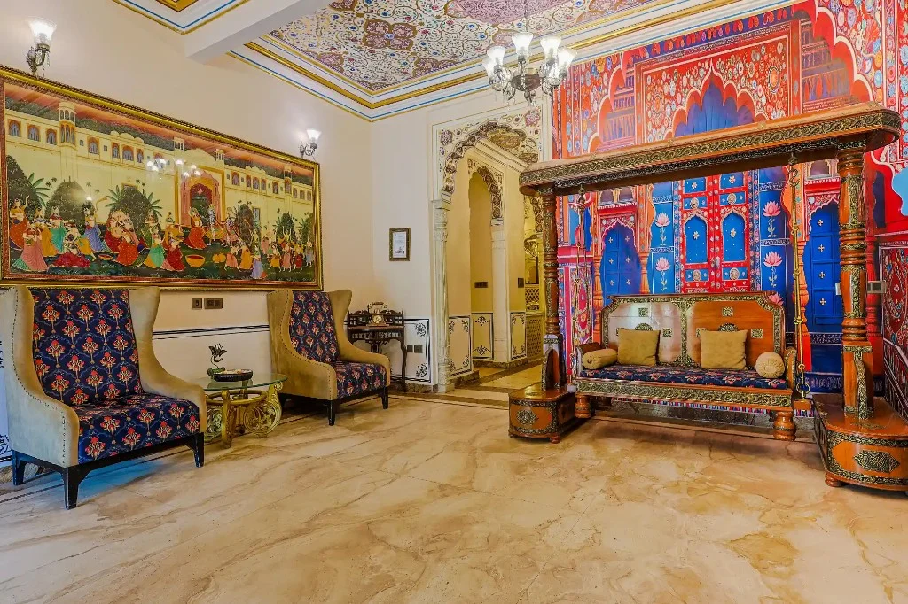 Heritage lounge with carved jhoola and painted ceiling — Traditional Heritage Haveli, Jaipur Heritage lounge with carved jhoola and painted ceiling — Traditional Heritage Haveli, Jaipur
